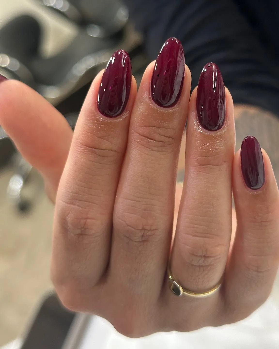 Glossy solid burgundy almond nails.
