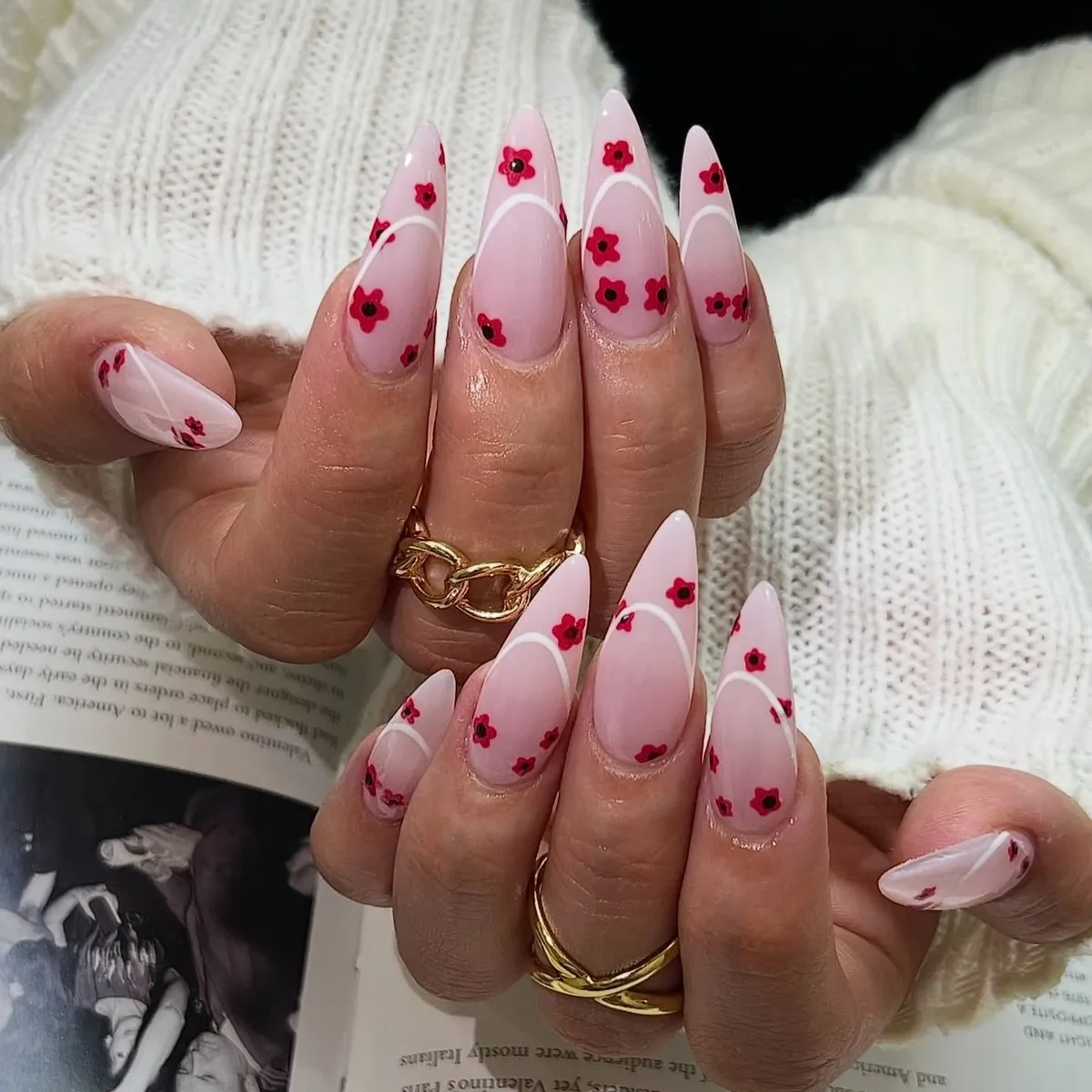 Almond nails with a clean white French edge and small painted cherry blossoms.