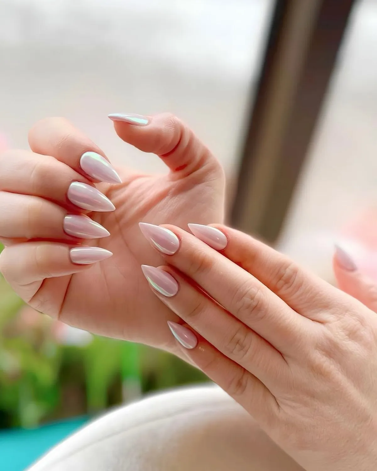 Soft milky-white almond nails with a pearly sheen.